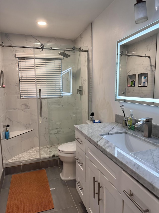 full bath with a marble finish shower, toilet, tile patterned flooring, vanity, and recessed lighting