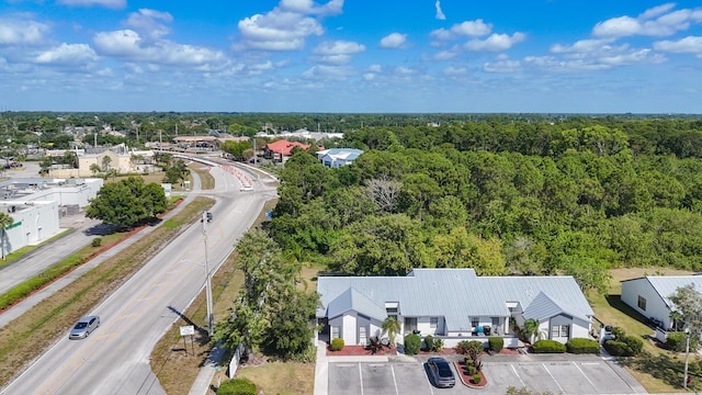 bird's eye view with a wooded view