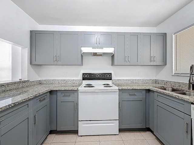 kitchen featuring gray cabinets, under cabinet range hood, and electric stove