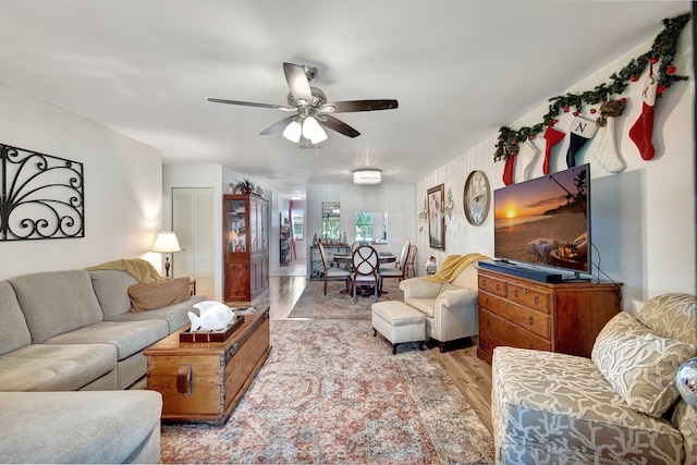 living room with ceiling fan and light wood-type flooring