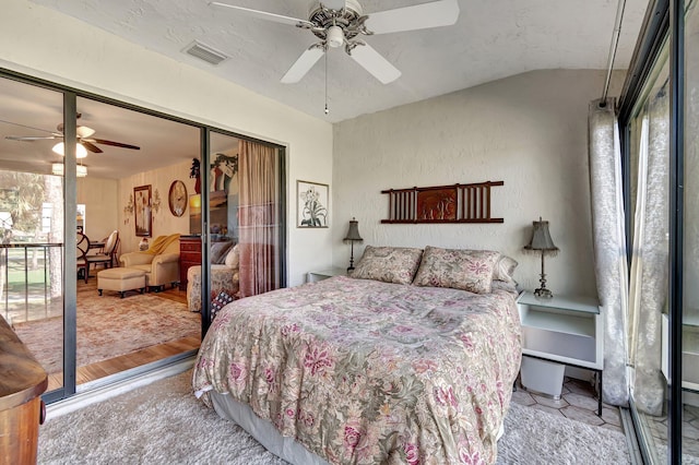 bedroom with hardwood / wood-style floors, lofted ceiling, ceiling fan, a textured ceiling, and a closet