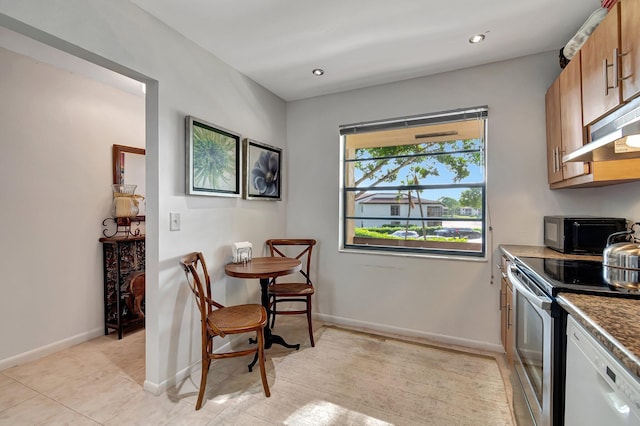 kitchen with stainless steel electric range, light tile patterned flooring, dishwasher, and extractor fan