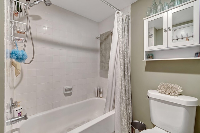 bathroom featuring shower / bath combo with shower curtain and toilet