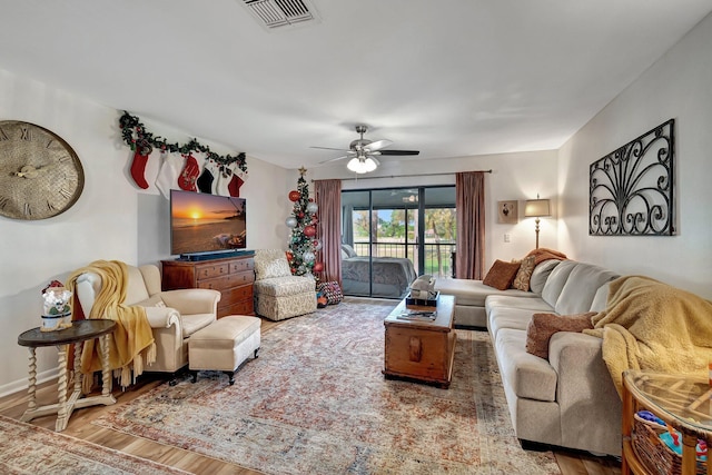 living room with hardwood / wood-style flooring and ceiling fan