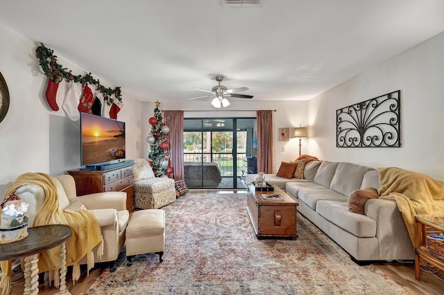 living room with ceiling fan and hardwood / wood-style floors