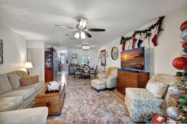 living room with light wood-type flooring and ceiling fan