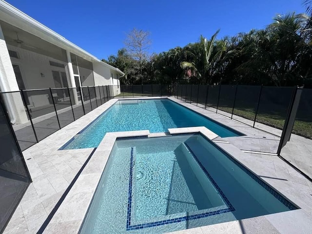 view of swimming pool featuring a patio area and an in ground hot tub