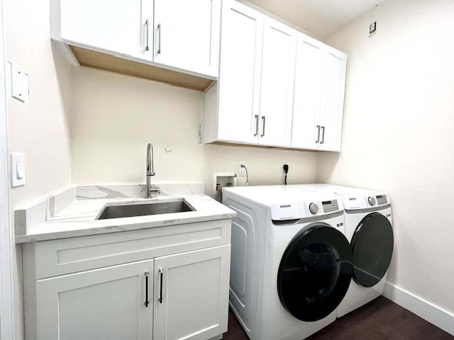 laundry room featuring cabinets, independent washer and dryer, and sink