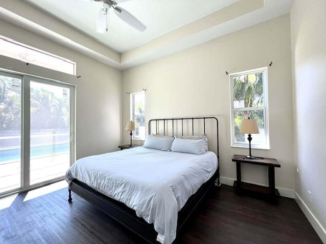 bedroom featuring access to outside, ceiling fan, and dark wood-type flooring