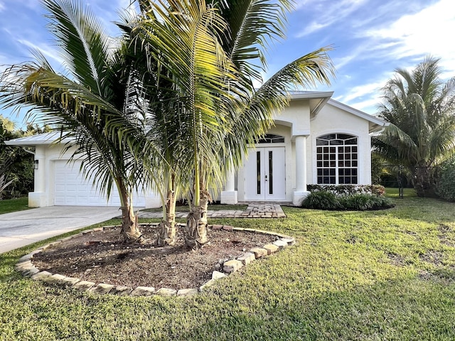 view of front of property with a front lawn and french doors