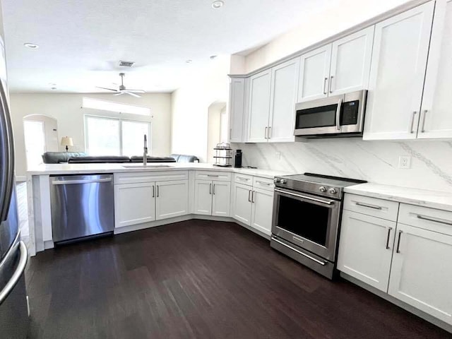 kitchen with white cabinets, dark hardwood / wood-style flooring, stainless steel appliances, and sink