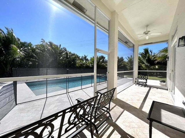 view of pool with ceiling fan and a patio