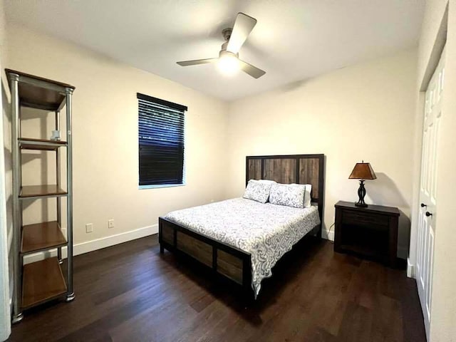 bedroom featuring ceiling fan, dark wood-type flooring, and a closet