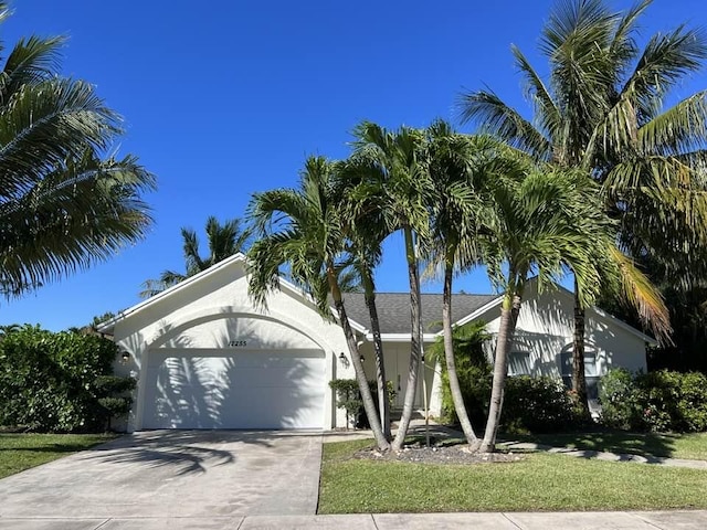 view of front facade with a garage and a front lawn