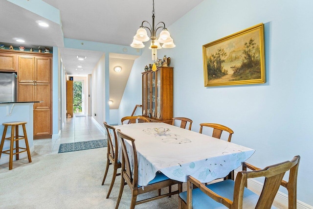 carpeted dining area featuring a notable chandelier