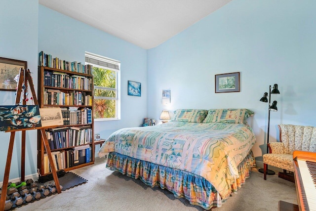 bedroom with carpet floors and vaulted ceiling