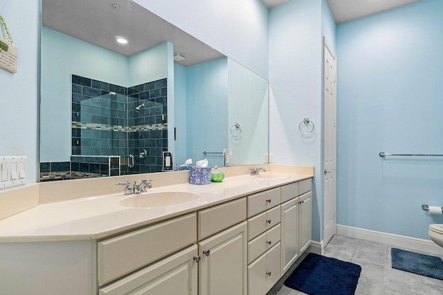 bathroom with tile patterned floors, a shower with door, vanity, and toilet