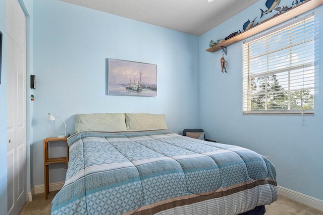 carpeted bedroom with a closet and a textured ceiling