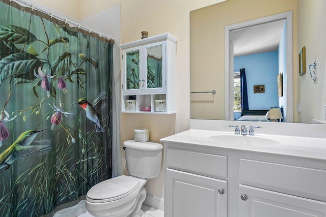 bathroom featuring tile patterned floors, vanity, and toilet