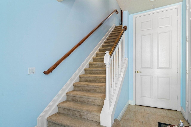 staircase with tile patterned floors