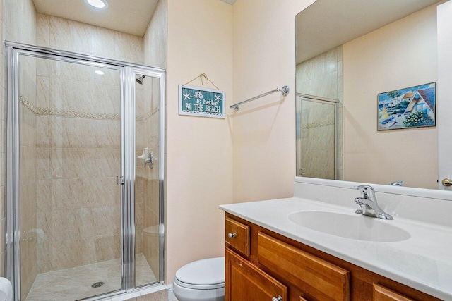 bathroom featuring vanity, toilet, and walk in shower