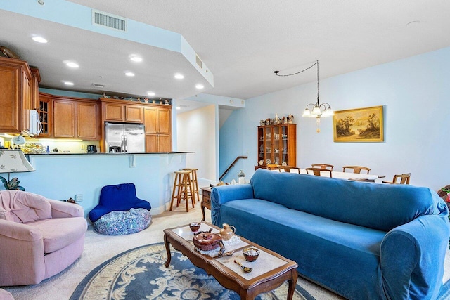 living room with a notable chandelier and light colored carpet