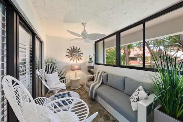 sunroom / solarium featuring ceiling fan