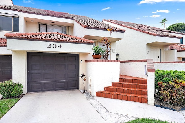 mediterranean / spanish-style home featuring a garage