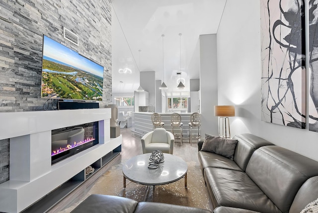 living room with wood-type flooring and a fireplace