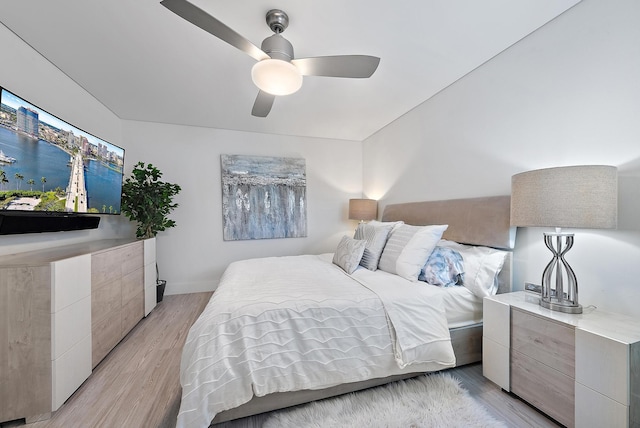 bedroom with ceiling fan and light wood-type flooring