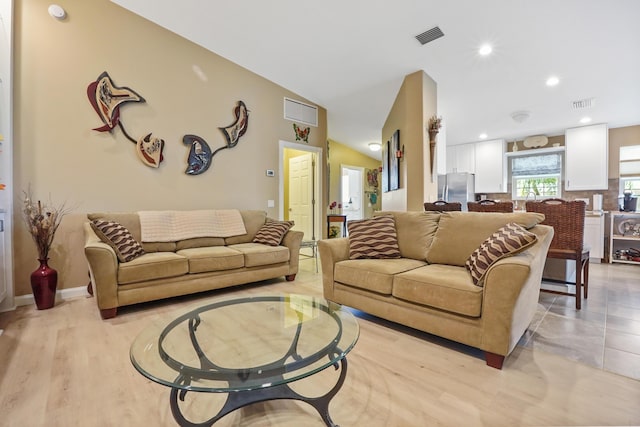 living room featuring light hardwood / wood-style flooring and lofted ceiling