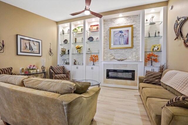 living room with ceiling fan and light wood-type flooring