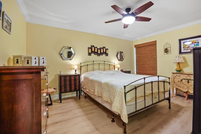 bedroom with ceiling fan, light wood-type flooring, and crown molding