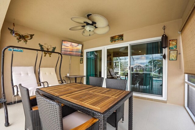 view of patio / terrace with ceiling fan and glass enclosure