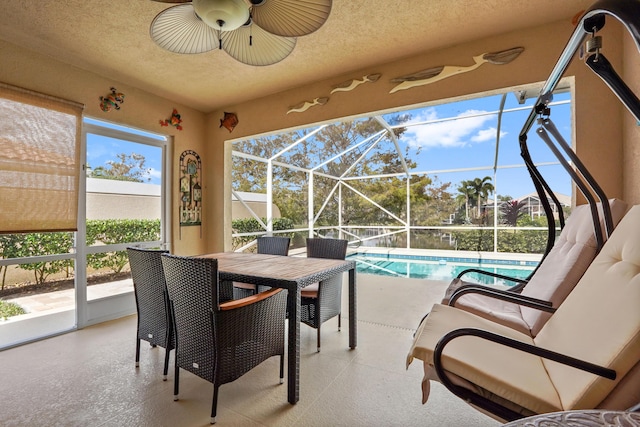 sunroom / solarium featuring ceiling fan and a pool