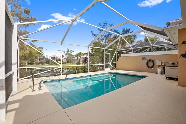 view of pool with a lanai, ceiling fan, and a patio