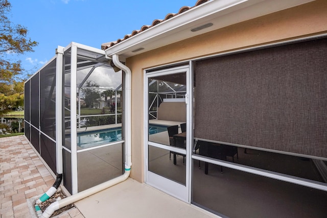 view of exterior entry with a patio