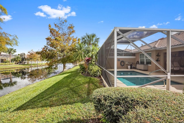 view of swimming pool featuring glass enclosure, a water view, and a yard