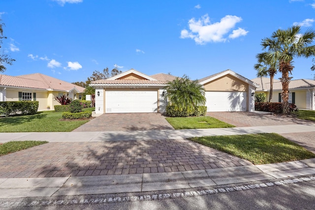 ranch-style home with a garage and a front yard