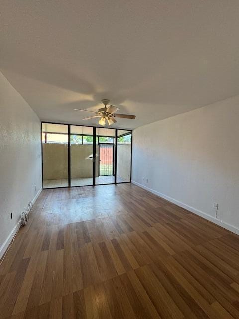 unfurnished room with ceiling fan and hardwood / wood-style flooring