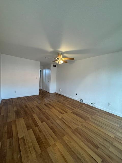 empty room with hardwood / wood-style flooring and ceiling fan