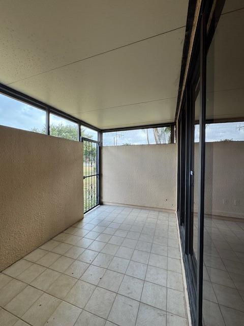 unfurnished sunroom featuring plenty of natural light