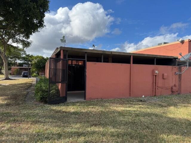 view of property exterior with a yard