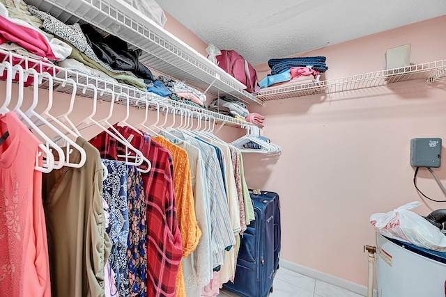 spacious closet featuring light tile patterned flooring