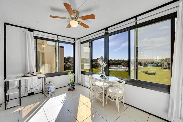 sunroom featuring ceiling fan