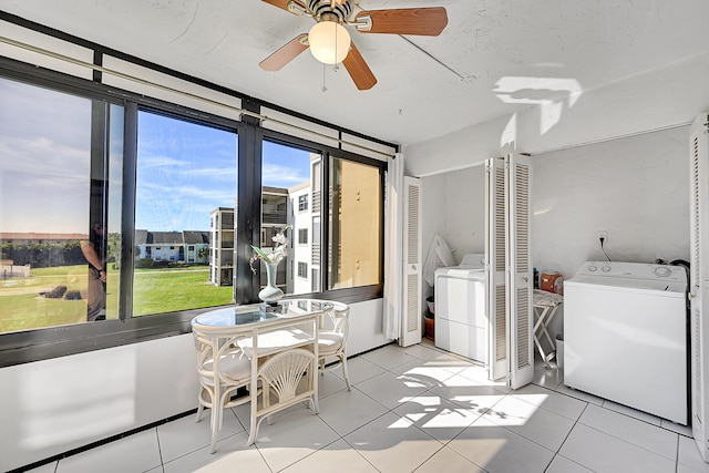 sunroom / solarium with ceiling fan and independent washer and dryer