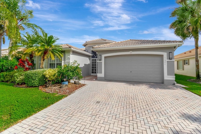 view of front of home featuring a garage and a front lawn