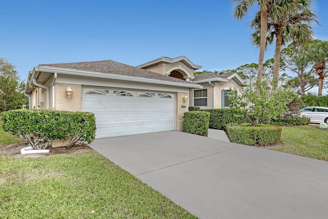 single story home with a front lawn, driveway, an attached garage, and stucco siding