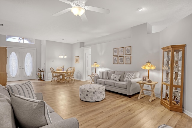 living room featuring french doors, light hardwood / wood-style floors, and ceiling fan