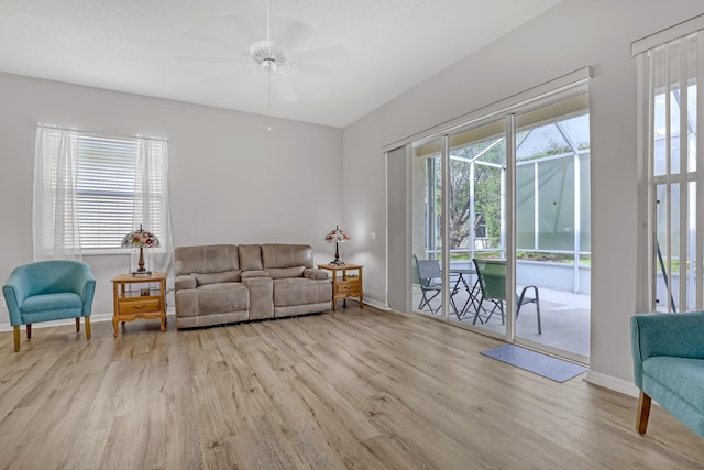 living room with ceiling fan, a healthy amount of sunlight, and light hardwood / wood-style floors